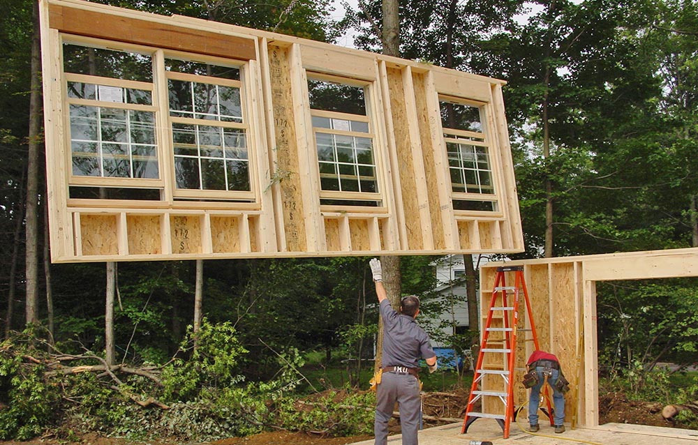 A completed panel being installed in a panelized home - prefab homes.