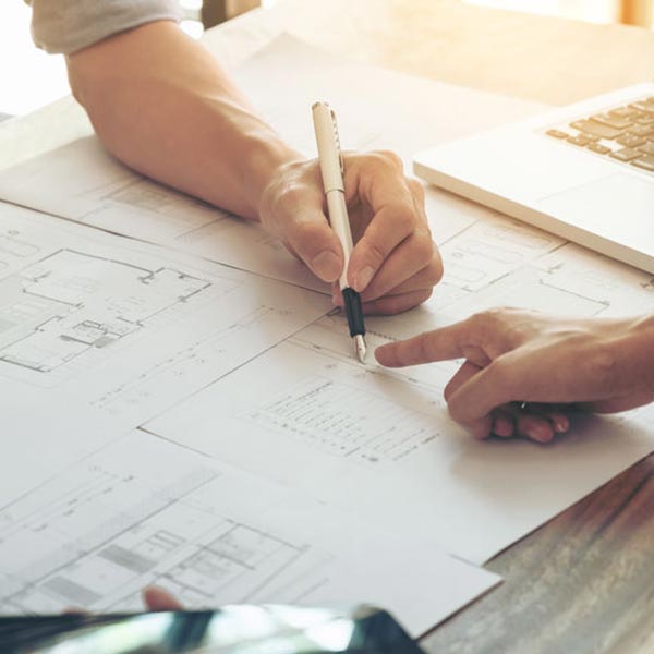 Designer and Home Builder Collaborating on Blueprints